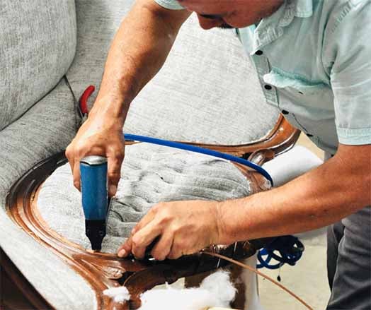 Juan, our upholsterer, working on settee 524