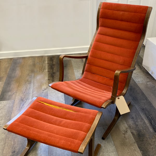 furniture upholstery: upholstered chair with ottoman before