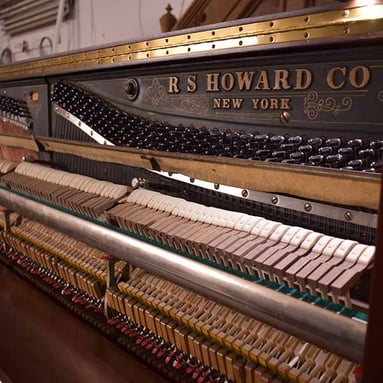 the interior of an R.S. Howard piano.